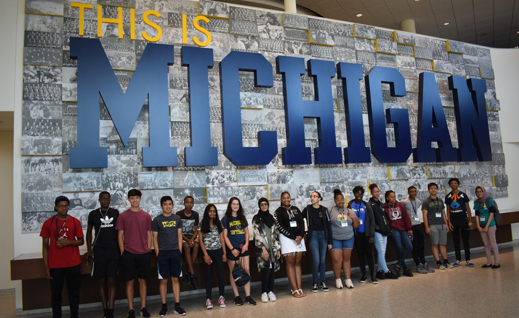 Students under "This is Michigan" display