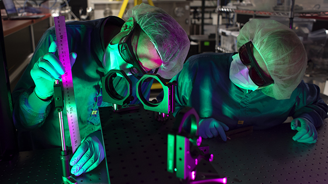 Research scientist John Nees and research engineer Galina Kalinchenko work on the ZEUS laser at the NSF ZEUS laser facility in a Michigan Engineering lab.